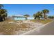 Exterior view of blue home with wood fence and scattered tree coverage at 6520 Clemson St, Bradenton, FL 34207