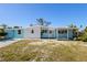 Charming single-story home with a light blue facade, white stone accents, and a covered front porch at 6520 Clemson St, Bradenton, FL 34207