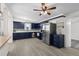 Well-lit updated kitchen with stainless steel appliances, blue cabinets, and modern finishes at 6520 Clemson St, Bradenton, FL 34207