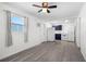 Open living area with wood-look flooring, natural light, and an efficient kitchen and laundry setup at 6520 Clemson St, Bradenton, FL 34207