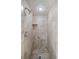 Modern walk-in shower with neutral-toned tiling, recessed lighting, and a built-in shelf for a spa-like feel at 6520 Clemson St, Bradenton, FL 34207