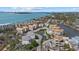 An aerial view of the coastal property offering stunning water views, palm trees and calm pond at 6924 Bochi Cir, Sarasota, FL 34242