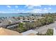 Waterfront property with tropical landscaping and serene water views of the ocean in a coastal community on a bright sunny day at 6924 Bochi Cir, Sarasota, FL 34242