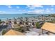 Stunning aerial view of a beachfront property with multiple buildings, palm trees, and oceanfront access at 6924 Bochi Cir, Sarasota, FL 34242