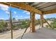 Exterior view from unfinished balcony framing homes and blue skies at 6924 Bochi Cir, Sarasota, FL 34242