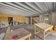 Spacious unfinished basement area with windows and staircase to upper level at 6924 Bochi Cir, Sarasota, FL 34242