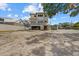A new home under construction shows the framing and site preparation with a blue sky backdrop in a residential area at 6924 Bochi Cir, Sarasota, FL 34242