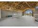 Open layout showcasing unfinished concrete block walls and exposed roof trusses, awaiting customization at 6924 Bochi Cir, Sarasota, FL 34242