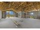Open floor plan with exposed concrete block walls and an unfinished wooden roof structure at 6924 Bochi Cir, Sarasota, FL 34242