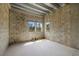 Unfinished room showing concrete block walls and window openings offering natural light at 6924 Bochi Cir, Sarasota, FL 34242