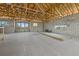 Spacious room under construction with concrete floors, cinder block walls and exposed wood beams at 6924 Bochi Cir, Sarasota, FL 34242