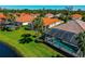 Stunning aerial view of a single Gathering house featuring a private pool, lush landscaping, and a picturesque lake at 708 Foggy Morn Ln, Bradenton, FL 34212