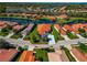 Aerial view of a lovely home with a red tile roof, lush landscaping, and water views at 708 Foggy Morn Ln, Bradenton, FL 34212