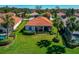 A lovely single Gathering home with a beautiful green lawn, lush landscaping, and an orange tile roof at 708 Foggy Morn Ln, Bradenton, FL 34212