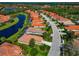 Community aerial view shows beautiful homes with tile roofs alongside a lake at 708 Foggy Morn Ln, Bradenton, FL 34212