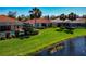 Back view of home showing lush landscaping, lanai, and serene water views at 708 Foggy Morn Ln, Bradenton, FL 34212
