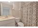 Bathroom showcasing a vanity, toilet, and shower with a patterned curtain at 708 Foggy Morn Ln, Bradenton, FL 34212