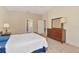Comfortable bedroom with neutral walls, ceiling fan, carpet, and a walk-in closet at 708 Foggy Morn Ln, Bradenton, FL 34212