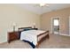 Spacious bedroom with carpet, ceiling fan, and an en-suite bathroom, offering a private and comfortable setting at 708 Foggy Morn Ln, Bradenton, FL 34212
