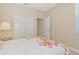 Bright bedroom features a floral comforter, closet, and a window with blinds at 708 Foggy Morn Ln, Bradenton, FL 34212