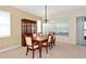 Inviting dining room featuring a classic dining set with a china cabinet and a view of the backyard at 708 Foggy Morn Ln, Bradenton, FL 34212