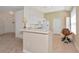 Bright kitchen with white appliances and cabinets, complemented by a convenient breakfast bar at 708 Foggy Morn Ln, Bradenton, FL 34212