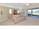 Spacious living room featuring neutral colors, fan, and lots of natural light from the backyard patio at 708 Foggy Morn Ln, Bradenton, FL 34212