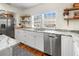 Bright and modern kitchen featuring marble countertops, stainless steel appliances, and open shelving at 717 84Th Nw St, Bradenton, FL 34209