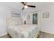 Comfortable bedroom with a queen bed, ceiling fan, and natural light at 7294 Cloister Dr # 7, Sarasota, FL 34231