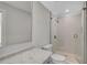 Bathroom with glass enclosed shower, white tile, and modern fixtures at 7523 S Leewynn Dr, Sarasota, FL 34240