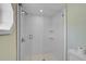 Bathroom with glass enclosed shower with white tile and brushed fixtures at 7523 S Leewynn Dr, Sarasota, FL 34240