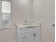 Bathroom with white vanity, bright light, and wood-look floors at 7523 S Leewynn Dr, Sarasota, FL 34240