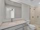 Bathroom with glass enclosed shower, marble countertop, and brushed fixtures at 7523 S Leewynn Dr, Sarasota, FL 34240
