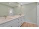 Bathroom featuring double vanity with white cabinets and light countertop at 7523 S Leewynn Dr, Sarasota, FL 34240