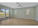 Bright bedroom with sliding glass door, ceiling fan and wood-look floors at 7523 S Leewynn Dr, Sarasota, FL 34240