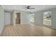Bedroom with wood floors, ceiling fan, natural light and access to ensuite bathroom at 7523 S Leewynn Dr, Sarasota, FL 34240
