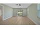 Bedroom with light green walls, wood floors, and sliding glass doors to backyard at 7523 S Leewynn Dr, Sarasota, FL 34240