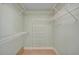 Walk-in closet with white wire shelving and wood-look floors at 7523 S Leewynn Dr, Sarasota, FL 34240