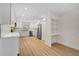 Modern kitchen with white cabinets, stainless steel appliances, and light wood flooring at 7523 S Leewynn Dr, Sarasota, FL 34240