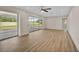 Bright living room with wood floors and sliding glass doors to a screened-in patio at 7523 S Leewynn Dr, Sarasota, FL 34240