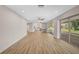 Living room with wood floors, recessed lights and sliding doors to lanai at 7523 S Leewynn Dr, Sarasota, FL 34240