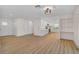 Bright living space with light wood floors, seamlessly connecting to the updated kitchen at 7523 S Leewynn Dr, Sarasota, FL 34240