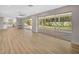 Bright living room featuring wood floors, recessed lighting, and sliding glass doors to lanai at 7523 S Leewynn Dr, Sarasota, FL 34240