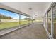 Enclosed patio with sliding glass doors overlooking the backyard and a view of blue skies at 7523 S Leewynn Dr, Sarasota, FL 34240