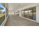 A bright enclosed patio with sliding glass doors provides an excellent view to the back yard at 7523 S Leewynn Dr, Sarasota, FL 34240
