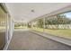 Covered back patio with views of a spacious fenced-in yard, providing great natural light at 7523 S Leewynn Dr, Sarasota, FL 34240