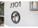 Close up of address numbers '7701' and property logo reading 'The Palms Anna Maria Island' at 7701 Palm Dr, Holmes Beach, FL 34217