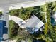 Birds-eye view of a nicely landscaped property including a backyard pool and patio at 7701 Palm Dr, Holmes Beach, FL 34217