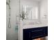 Elegant bathroom featuring a modern vanity, sleek mirror, and glass-enclosed shower at 7701 Palm Dr, Holmes Beach, FL 34217