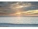 Picturesque beach view with a tranquil ocean and a colorful sunset at 7701 Palm Dr, Holmes Beach, FL 34217
